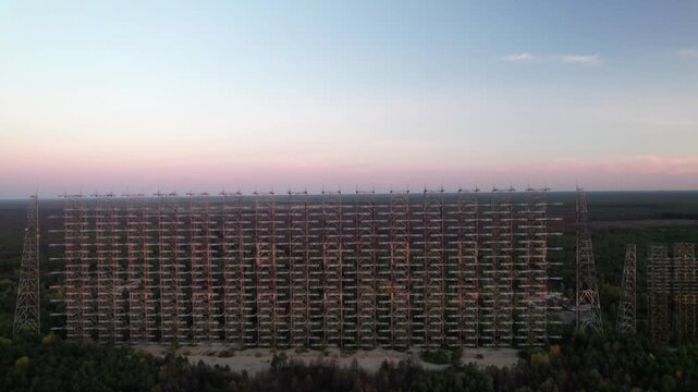 Aerial view of the massive Duga 1 Receiver radar array standing amidst the forest landscape in Chernobyl, Kyiv Oblast, Ukraine.
