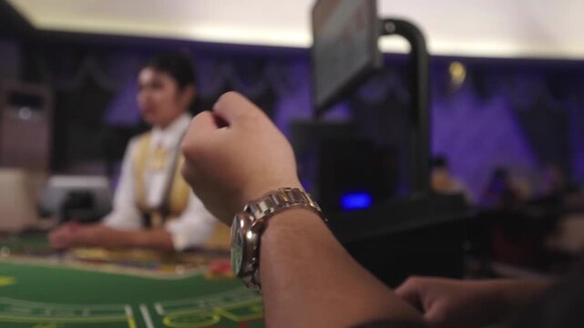 Cinematic casino table gaming scene with a male player tossing the casino chips for a commercial scene.