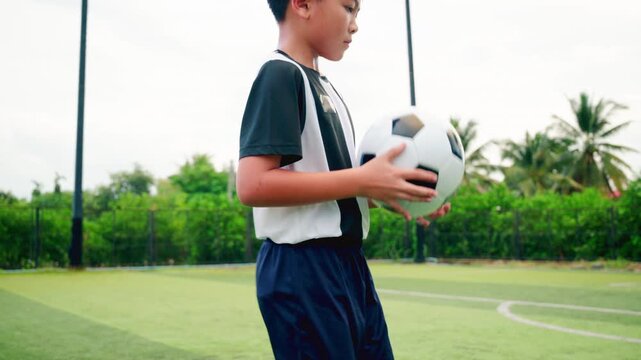 Kid boy leg kicking soccer ball on green grass field action. conceptual metaphor for youth sports training team competition fitness health wellness and active lifestyle	