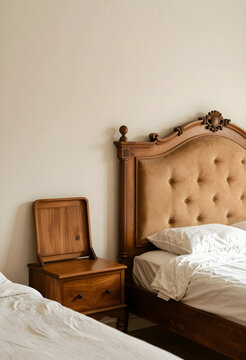 Hospitality and luxury travel, vintage wooden bed frame with tufted headboard and bedside table in a boutique hotel room with minimalist interior design