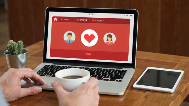 Online dating app interface on laptop with coffee cup and tablet in cafe setting