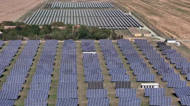 Aerial view of solar panel system in rural landscape with rows of photovoltaic panels in Spinetta Marengo, Piedmont, Italy.