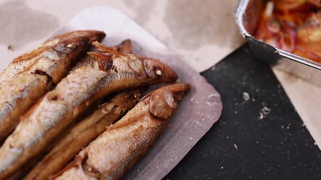 Cooking fish at a kitchen table in a home setting with a focus on preparation and presentation