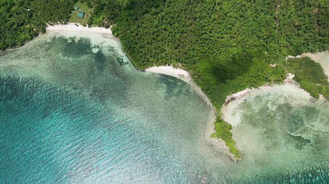 Green coastline with sandy coves leading into turquoise water of the tropical sea. Camotes, Philippines. Mesiyas Beach.