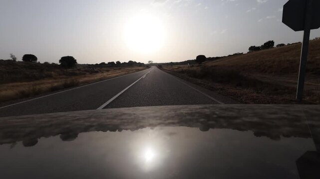 Driving Into Blinding Sunset on a Remote Rural Road