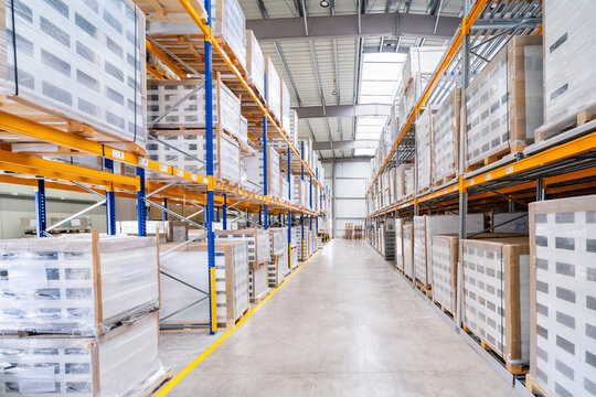 Interior of a large industrial warehouse with goods on shelves