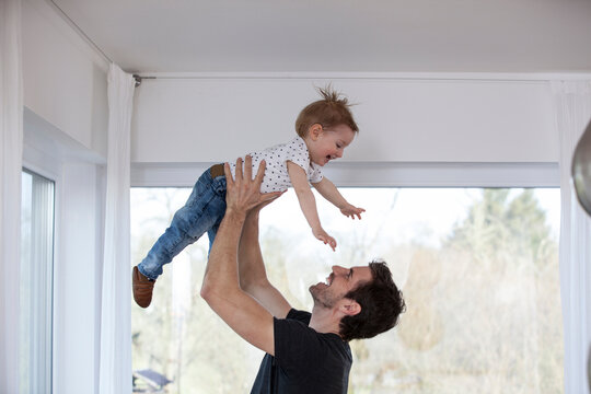 Happy father lifting laughing son