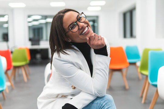 Happy female professional with hand on chin in education training class