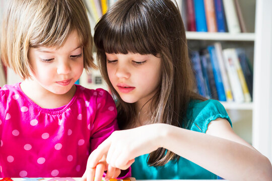 Portrait of two sisters playing together
