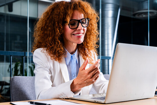 Smiling businesswoman gesturing during a video call at the office