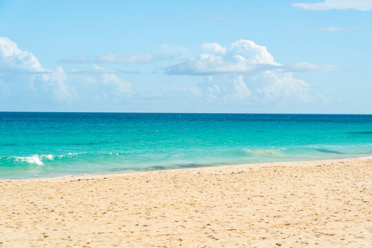 Empty sandy beach meets turquoise water in Corralejo Fuerteventura