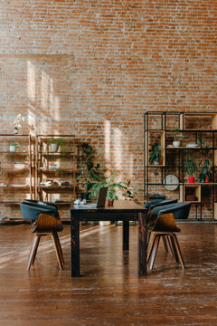 Modern office interior with wooden desk and brick wall in loft style