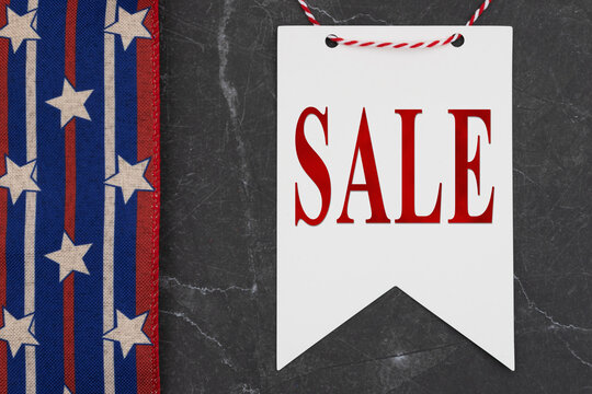 Sales text on white pennant banner hanging with ribbon for the holiday