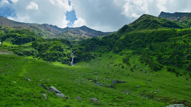 Sunlit Capra Waterfall Across Green Valley