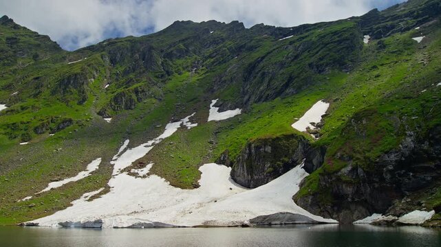 Wide Balea Lake Beneath Snowy Fagaras Slopes