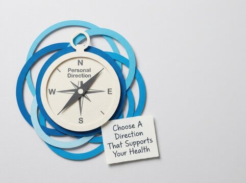 Flat lay paper cut compass icon with Personal Direction text on white background and blue circular layers including health motivation sticky note advice for wellness goals.