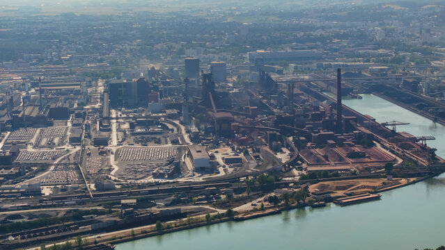 Aerial view of the large steel manufacturing and metallurgical industrial complex with blast furnaces, smokestacks, and storage yards along the Danube river in Linz, Upper Austria, Austria.