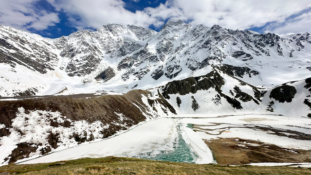 Mount Cheget and the famous Semerka glacier in the Elbrus region of Kabardino-Balkaria. The partially frozen high-mountain lake Donguz-Orun Kol is visible below.