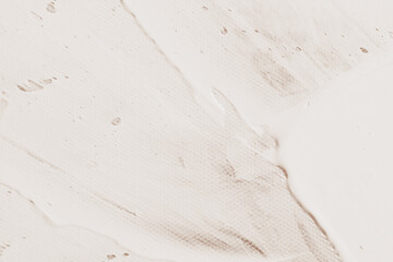 Textured surface with subtle patterns and light stains, showcasing a soft color palette of beige and cream, ideal for backgrounds or design elements in various applications