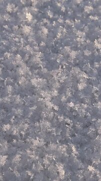 Texture of fresh loose snow in sunlight close-up. View of clean snow surface, texture of white snow, winter abstract background, snowy surface with natural crystal structure. Winter