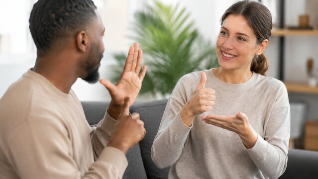 Diverse Couple Communicating with Sign Language During Friendly Conversation at Home