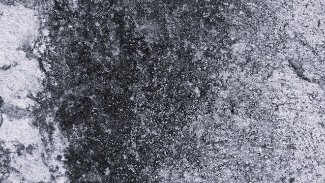 Light monochrome grunge texture with rough granular surface, weathered patches and subtle contrast, ideal for neutral backgrounds, wallpapers, posters, and graphic design.