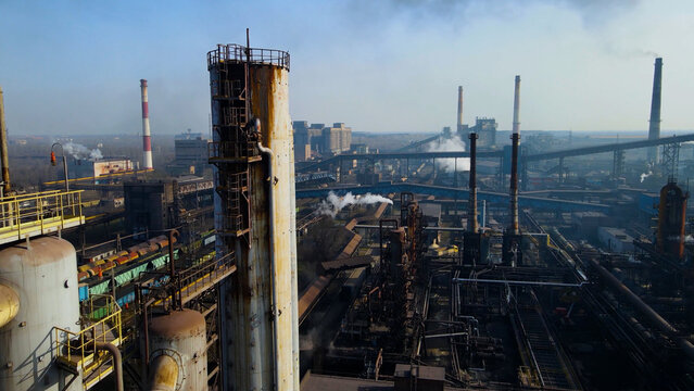 Factory, industrial enterprise, metallurgical plant, smoke from chimneys, aerial photography from a drone.