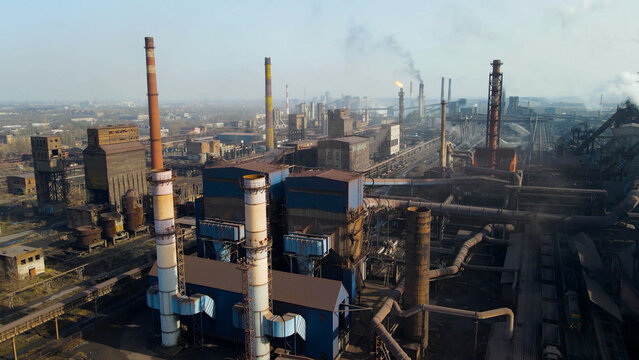 Factory, industrial enterprise, metallurgical plant, smoke from chimneys, aerial photography from a drone.