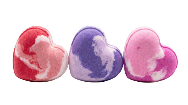 Three heart shaped bath bombs in red, purple, and pink colors isolated on transparent background