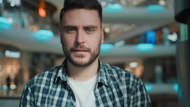 Unhappy Caucasian man showing thumb down gesture looking at camera with negative opinion disagreement bad news in shopping mall business male client sad businessman demonstrate dislike sign indoors
