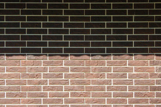 Brown brick wall imitation siding panel texture background close up