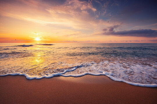 Beach sunrise over the tropical sea shore