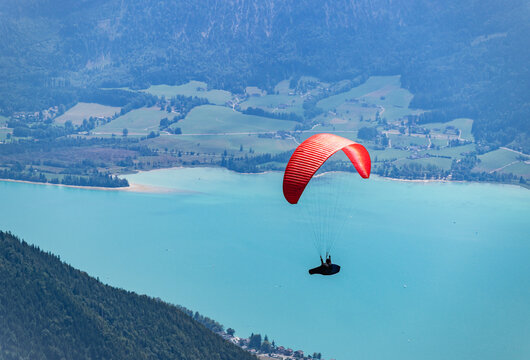 Paraglider paragliding recreation above lake. Paragliding sport activity. Parachute in the sky. Extreme paragliding. Summer vacation extreme sport. Parachute paraglide. Sport and activity lifestyle