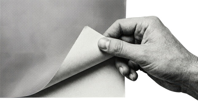 Hand peeling back corner of textured halftone paper sheet