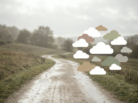 Dirt road through a grassy field with paper cloud shapes overlaid in soft daylight