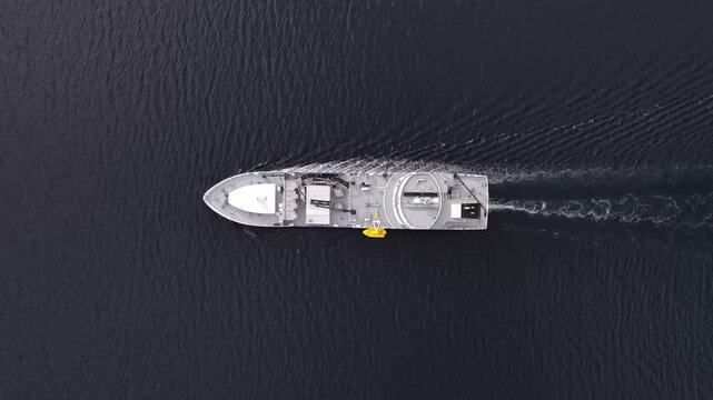 Aerial view of wellboat navigating through deep blue water in Liabygda, More og Romsdal, Norway.