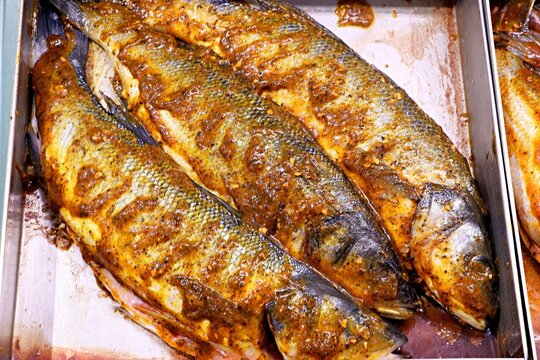 Fresh fish Sander lucioperca, pike perch carcasses in marinade