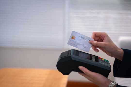 Credit card payment terminal for financial advisor wealth planning and secure indoor business transaction with hand holding payment card