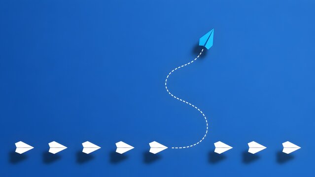 Blue paper airplane breaking away from white fleet symbolizing individuality and strategic business disruption