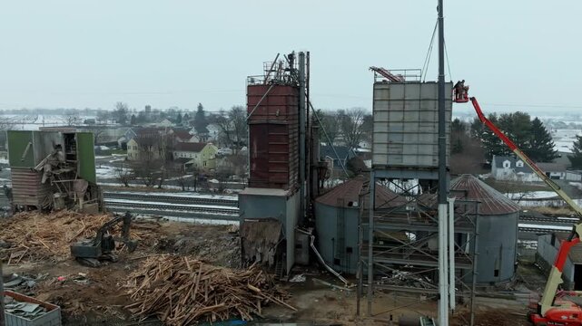 Gordonville, Pennsylvania, United States - 19 February 2026: Aerial view of industrial demolition site with silos, debris, and a crane in a rural setting.