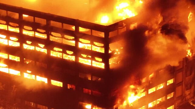 Chittagong, Bangladesh - 16 October 2025: Aerial view of a massive fire engulfing an industrial building at the Chattogram EPZ with bright flames and thick smoke.