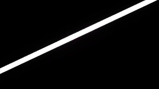 A motion graphic background featuring a diagonal neon laser light flare moving smoothly across a dark surface with floating dust particles, creating a futuristic and cinematic lighting effect.
