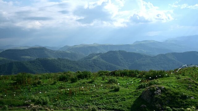 Panning Shot of Mountain Ranges and Green Meadows