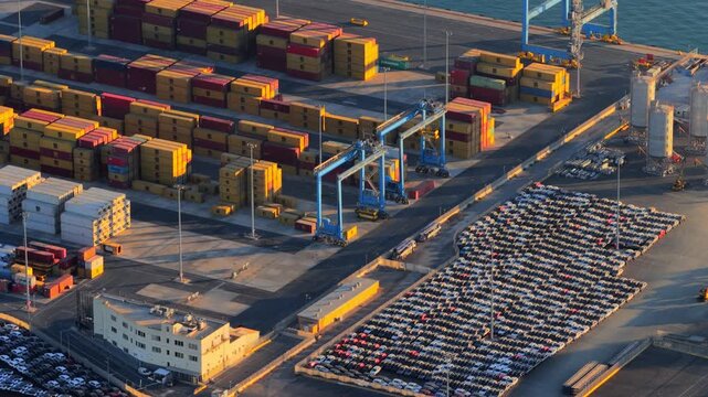 Civitavecchia, Lazio, Italy - 23 August 2026: Aerial view of Civitavecchia Port featuring rows of shipping containers, parked vehicles, and industrial gantry cranes.