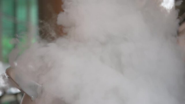 Liquid nitrogen vapor fog laboratory science experiment flask chemistry smoke cold dense white mist from cryogenic fluid pouring in glass container indoor lab background