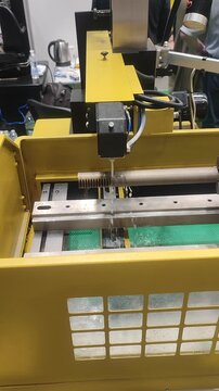 Electric Discharge Machining. Wire-cut electrical discharge machining EDM on CNC machine. Machine cutting metal, wire containing electrical discharges in dielectric. High-precision process Vertical