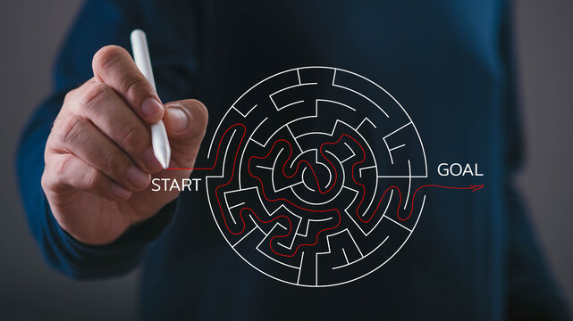 Business strategy concept showing a professional drawing a path through a complex maze from start to goal, symbolizing strategic planning, problem solving, decision making, focus, progress, success.