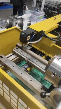 Wire-cut electrical discharge machine. Operation of wire-EDM machine cutting metal parts. Electrical discharge machine EDM cutting metal workpiece. Cutting process by wire cut machine. Vertical