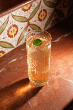 Sparkling Highball Cocktail with Clear Ice Block and Mint Leaf Garnish