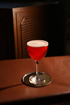 Red Alcoholic Sour Cocktail with Foam in Stemmed Glass Close Up